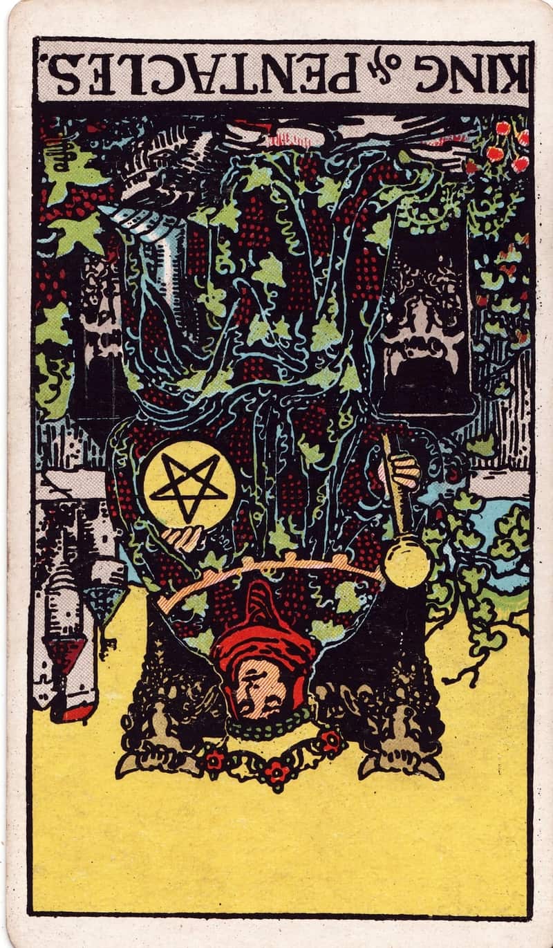 King of Pentacles reversed tarot card