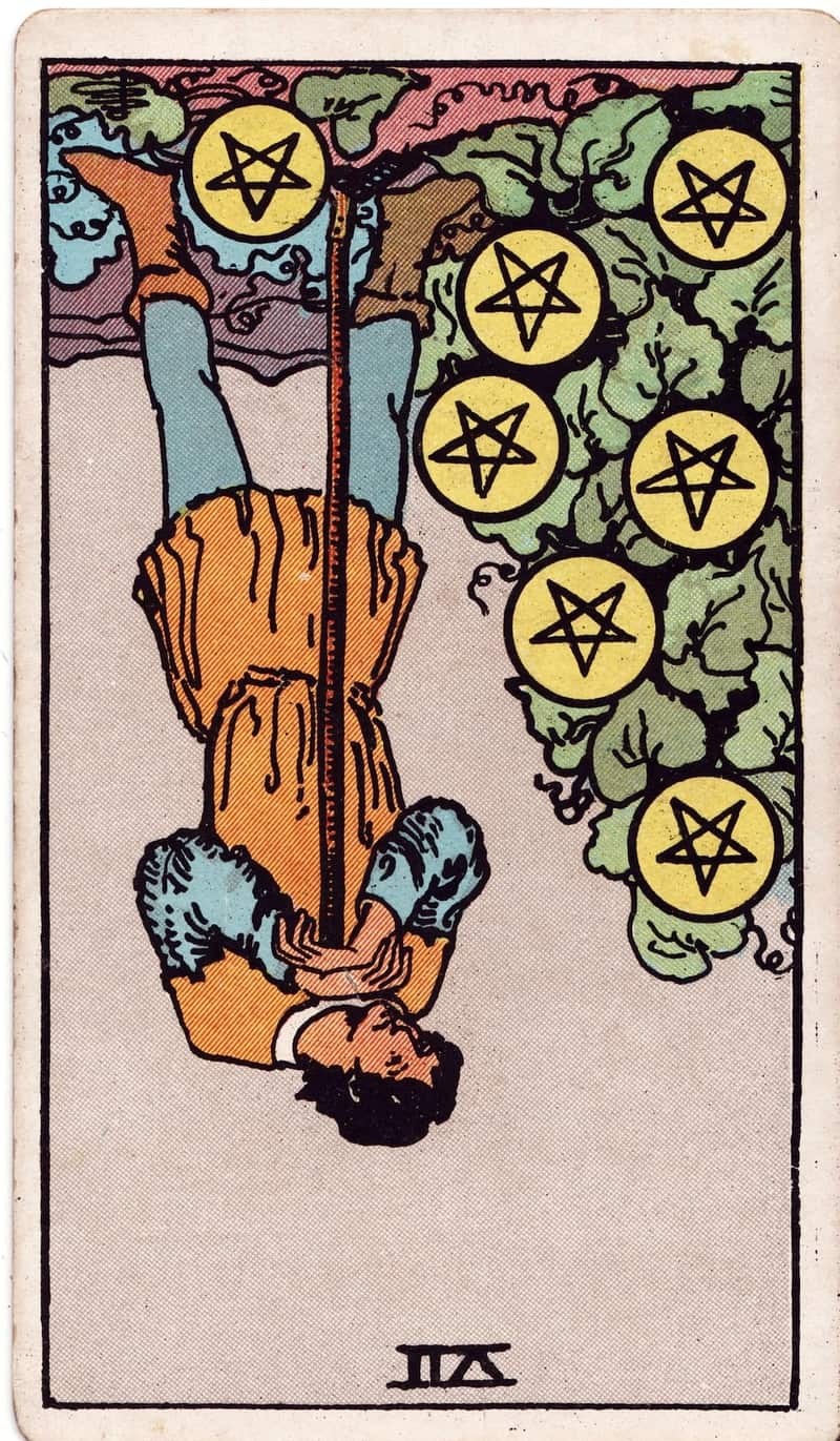 Seven of Pentacles reversed tarot card