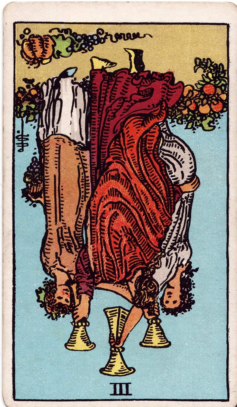 Three of Cups reversed tarot card